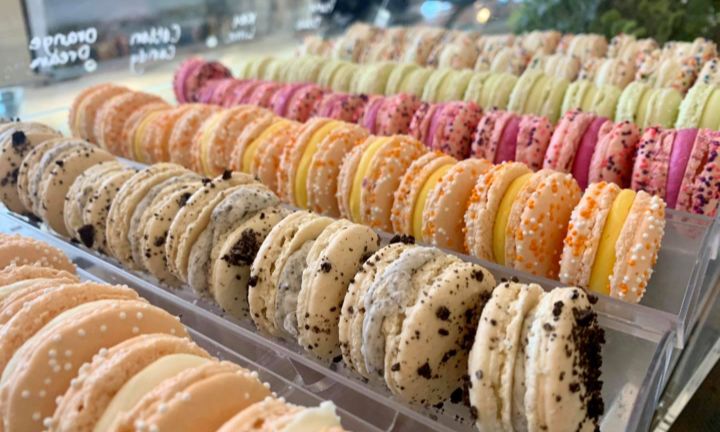 Rows of colorful French macarons in the Sweet Melissa display case