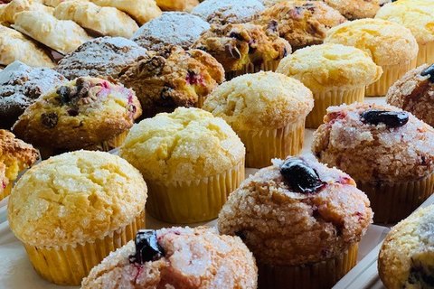 Trays of large assorted muffins with sugar-crusted tops