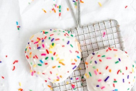 Lemon iced ricotta cookies topped with rainbow sprinkles